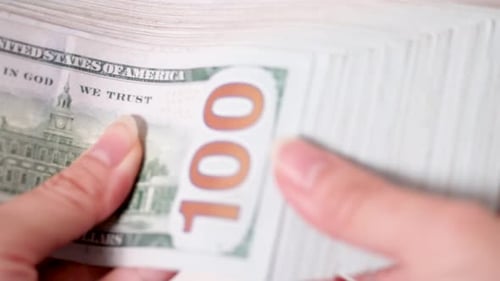 Close up of female hands counting 100 American dollars in white background