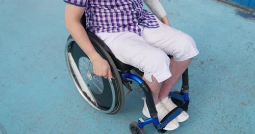 Person in Wheelchair Propelling Forward