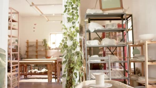 Desks, shelfs and potter's wheel in pottery studio
