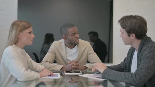 Colleagues at Conference Table Discussing Business