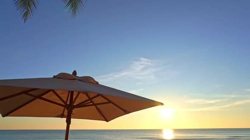 Tropical Vacation Scenery. Sunshade Umbrella, Palms and Sunset on Sea Horizon, Tropical Beach Sereni