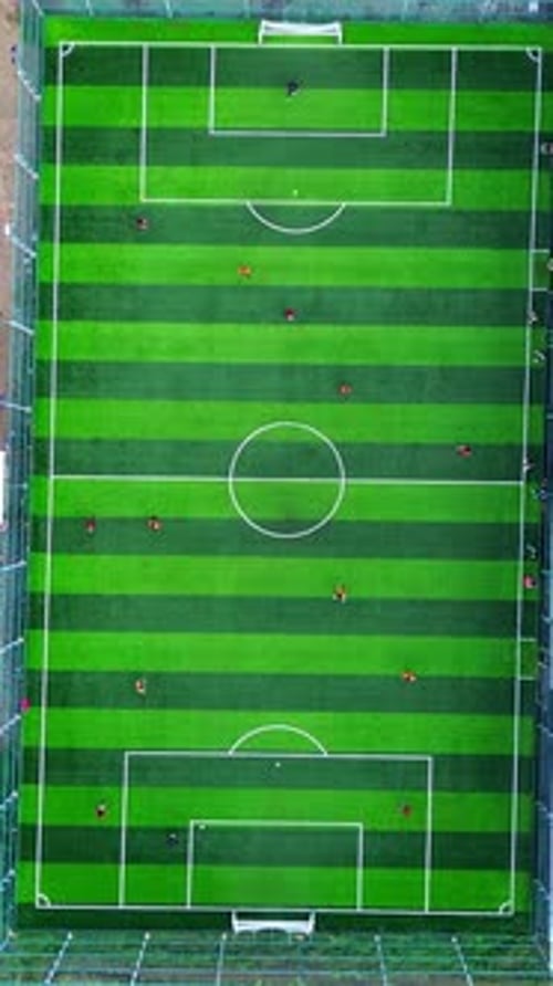 Vertical Drone Footage of mini football match, soccer. MiniFootball field and Footballers from drone