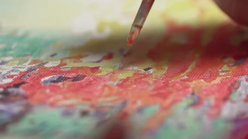 Female with brush drawing. Paint by numbers close up.