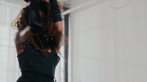 Woman With Curly Hair Dancing In A Minimalist Studio