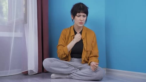 Upset Young Woman Expressing Sadness Indoors