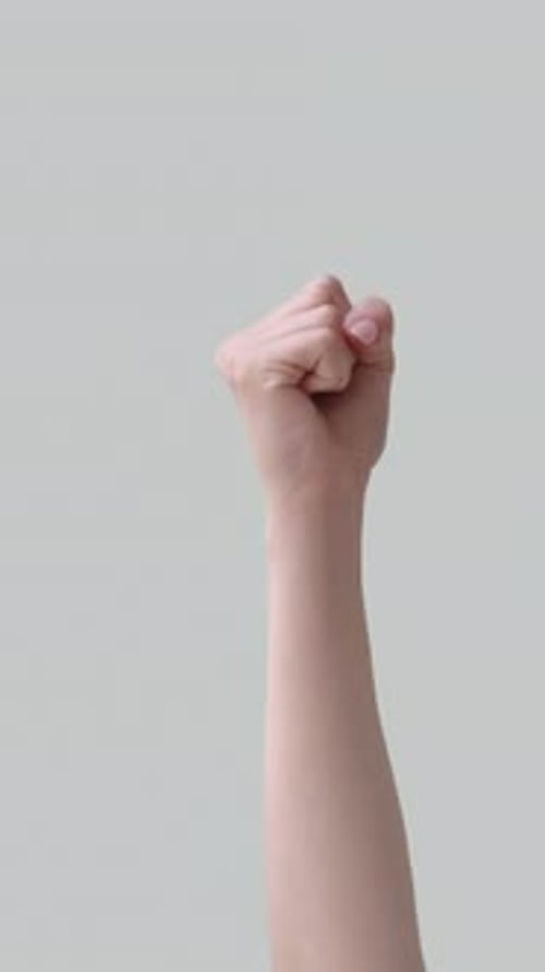 Arm and Hand Making Fist Isolated on Gray