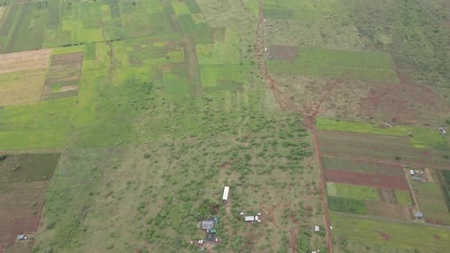 Countryside and farmlands in Southern Kenya, contemporary agriculture in Africa, aerial tilt down
