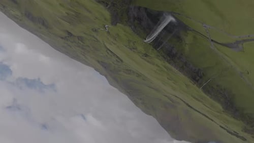 Majestic Waterfall and Green Hills in Iceland