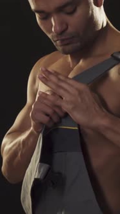 Charming Muscular African Male Builder Showcasing Strength in Work Attire