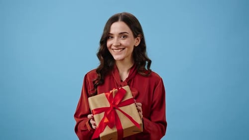 Smiling Woman Offering a Birthday Gift
