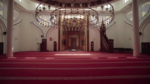 Cinematic movement from a grand chandelier to the Mihrab with red carpet inside a mosque in Bar, Mon