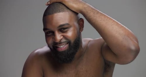 Hair, skincare and face of black man in studio for beauty, shampoo and grooming