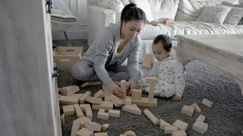 Mother and Child Play with Wooden Building Blocks
