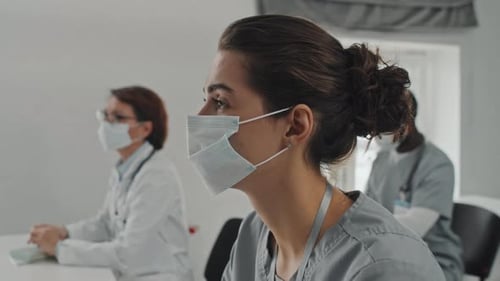 Young Nurse Listening To Professor
