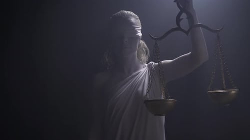 Lady Justice Holding Balance Scales in Studio