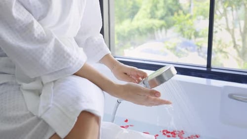 Woman Preparing Luxurious Bath with Flower Petals