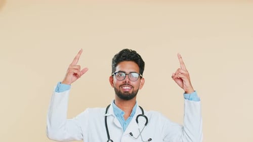 Doctor Man Showing Thumbs Up and Pointing on Blank Space Place for Advertisement Promotion Logo
