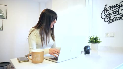 Businesswoman working with a computer sitting at home, business via home office, telecommuting