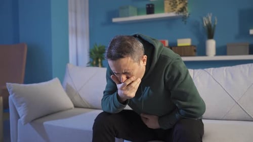 A sick man with a stomachache.