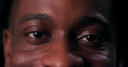 The Infectious Joy of an African American Man Shines Through His Eyes in a Closeup Shot That
