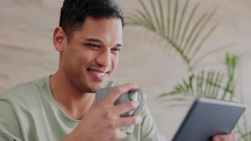 Man Smiling with Tablet and Mug Indoors