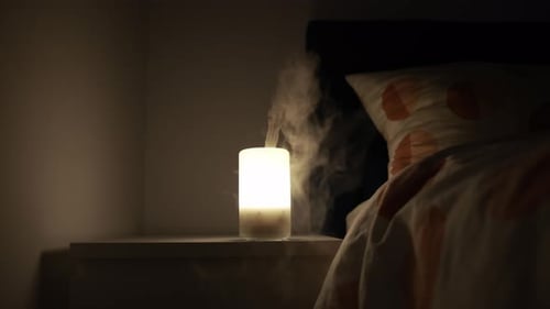 Humidifier Emitting Vapor in a Dark Bedroom