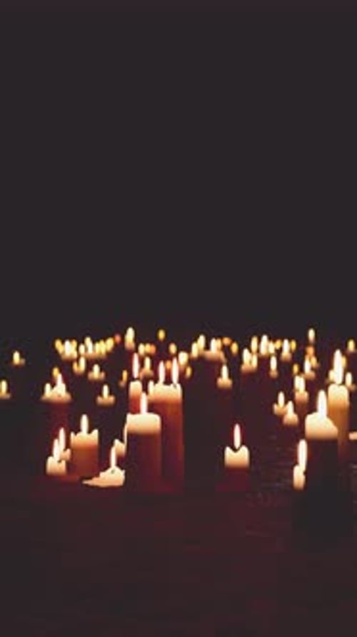 Many Lit Candles in Darkness