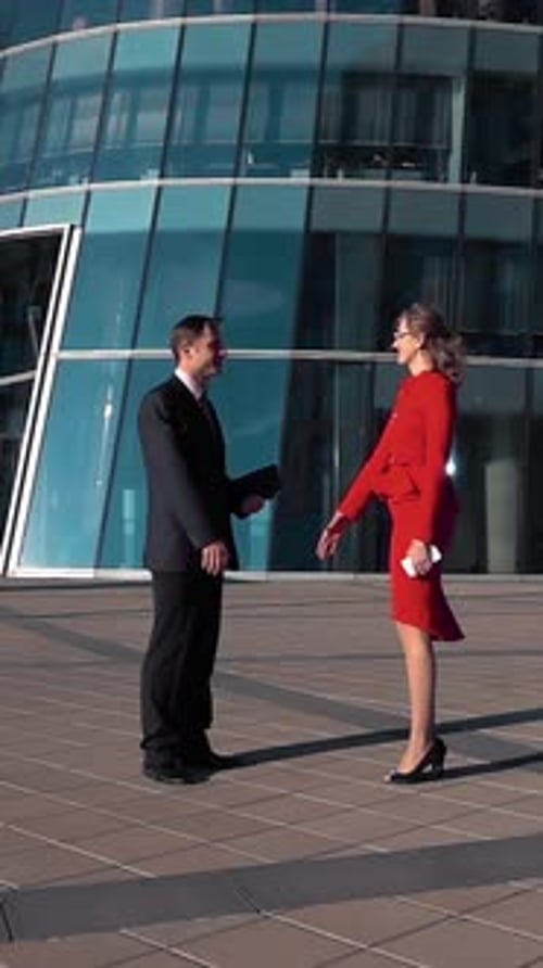 Business People Shaking Hands Outside Office Building