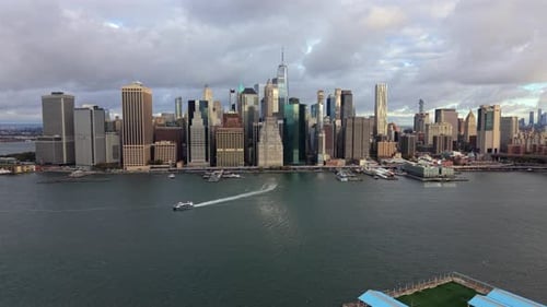 Aerial View of Lower Manhattan Skyline with Ferry Wake Across Hudson River Waters