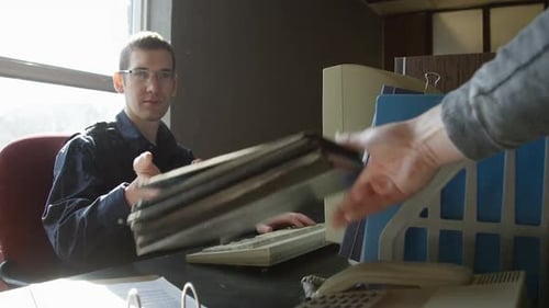 Police officer overworked at desk in old precinct HD