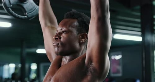 Exercise, weightlifting and workout with black man in gym for bodybuilding or strength training