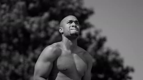 Intense one on one street basketball game in urban park showcasing athleticism