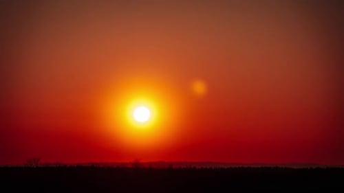 Timelapse of Sunset in the Orange Sky Over the Horizon