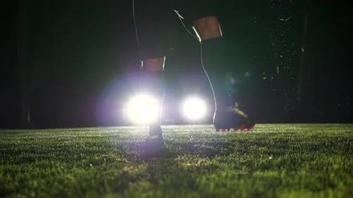 Football player at training on football field at night