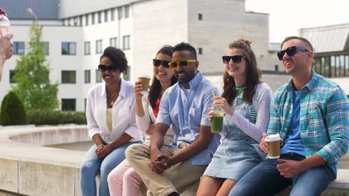 Friends Sitting and Laughing in Sunny City Location