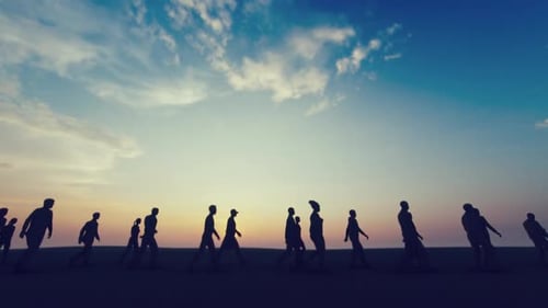 People Silhouettes Walking Across Horizon at Sunset
