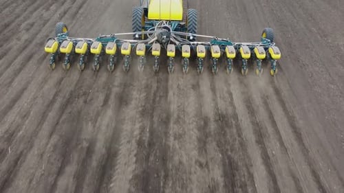 Blue tractor OA working on the field in Ukraine