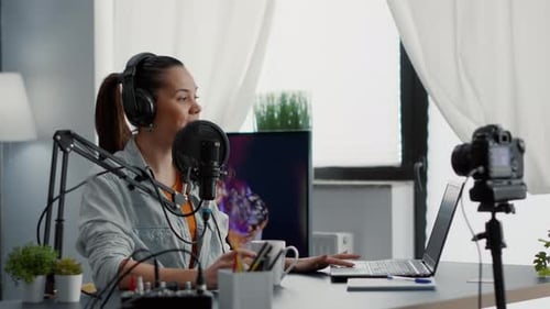 Famous Vlogger Sitting at Home Studio Desk While Recording Video Blog