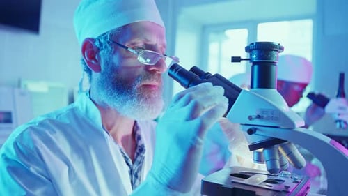 Scientist Analyzing Sample with Microscope in Laboratory