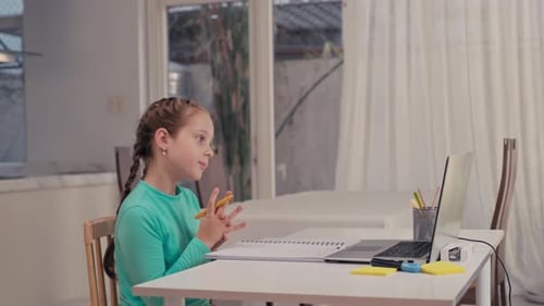 Girl Learning Online at Desk in Bright Home