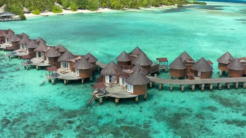 Overwater Villas in Tropical Lagoon of Moorea Island with Coral Reef