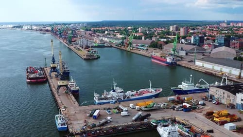 Aerial View Of Port Of Klaipeda, a cargo ship terminal on the shore of Baltic sea during summer In L