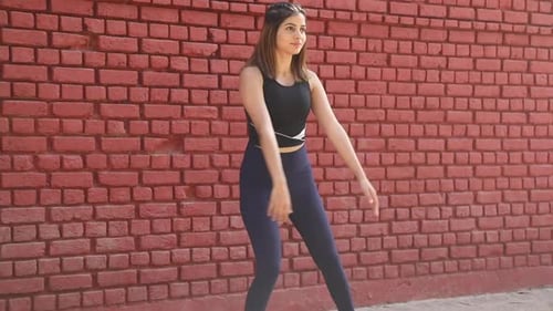 Video footage of squat and feet together aerobic cardio workout exercise.