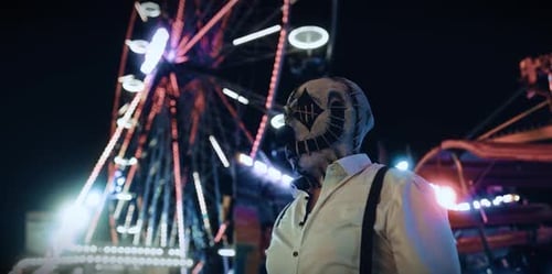 Masked Figure at Night with Ferris Wheel