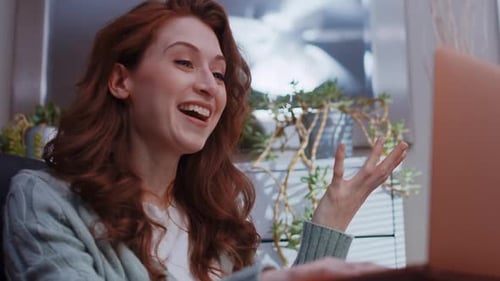 Excited Woman Celebrates Success While Using Laptop