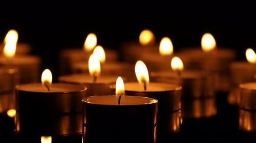 Burning candles glowing in the dark room, remembrance