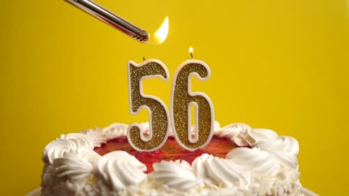 56. A candle in the form of the number 56 is lit, which is stuck into the holiday cake. Celebrating