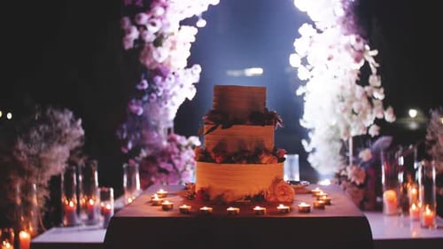 Wedding Cake Display with Floral Arch and Candles