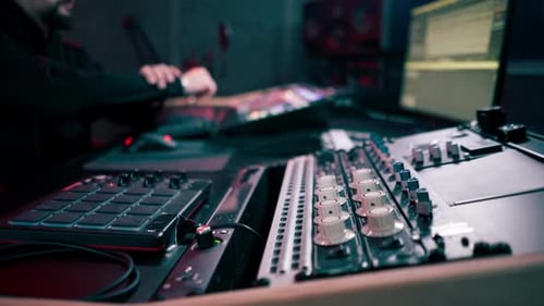 in the Recording Room Dark with Neon Lighting in the Studio the Sound Engineer Works at the Console