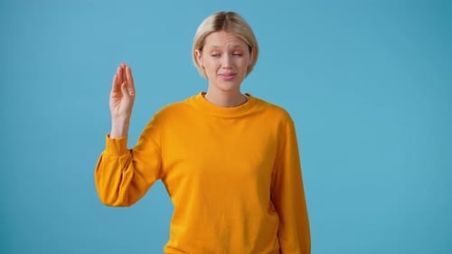 Woman Gesturing Confusedly Describing Something on Blue Backdrop